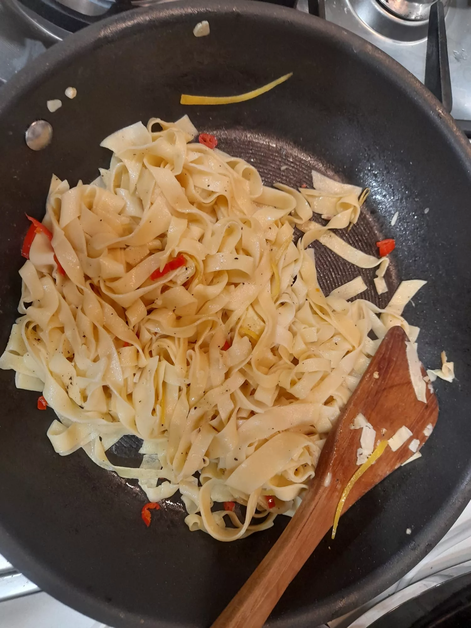 Pasta being cooked with chilli, garlic and lemon